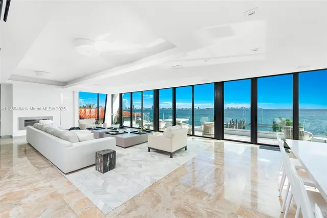 a living room with furniture and large windows