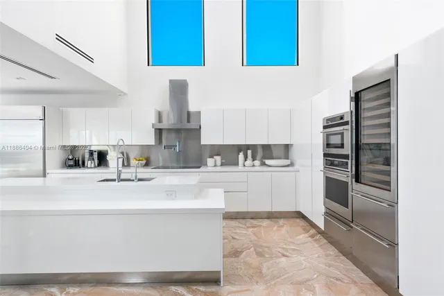 a kitchen with a refrigerator and a sink