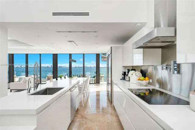 a large white kitchen with a large window
