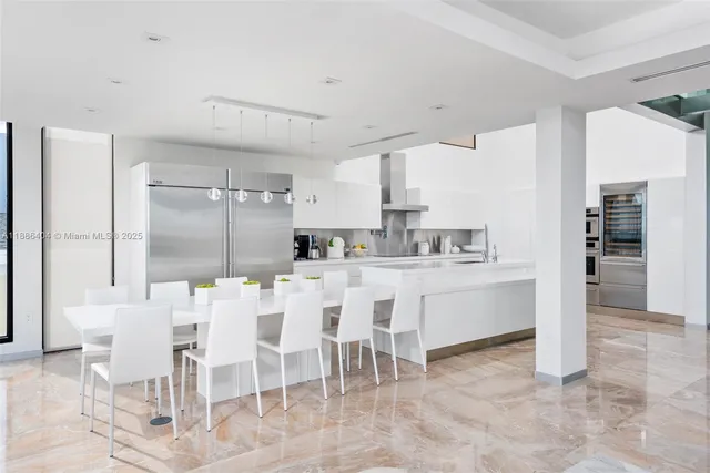 a kitchen with cabinets and chairs