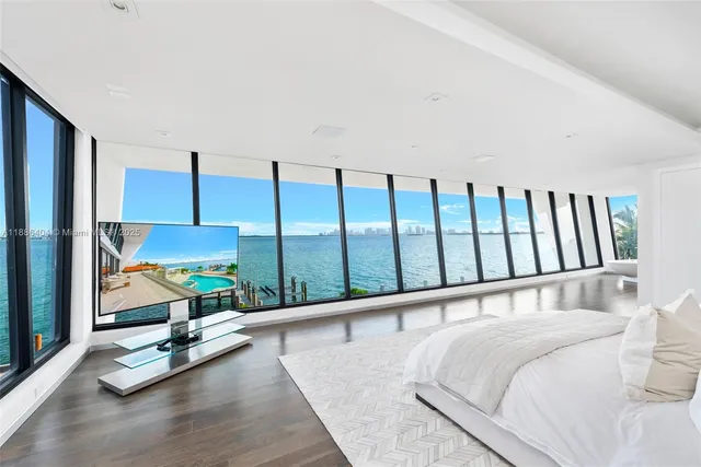 a bedroom with a bed and large window