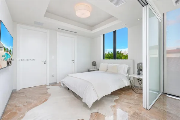 a bedroom with a large bed and a window
