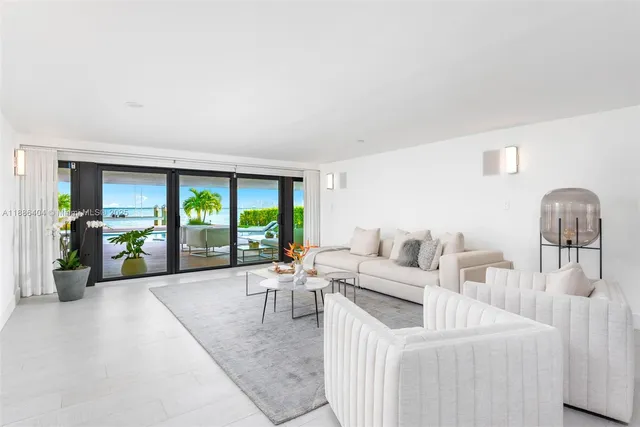 a living room with furniture and large windows
