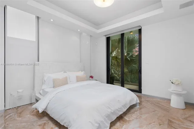 a bedroom with a bed and a large window