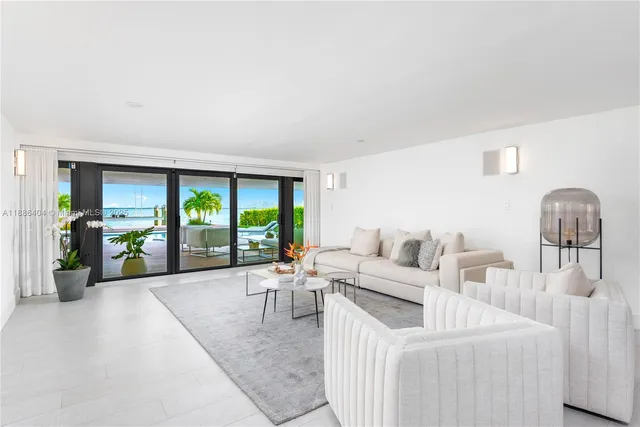 a living room with furniture and large windows
