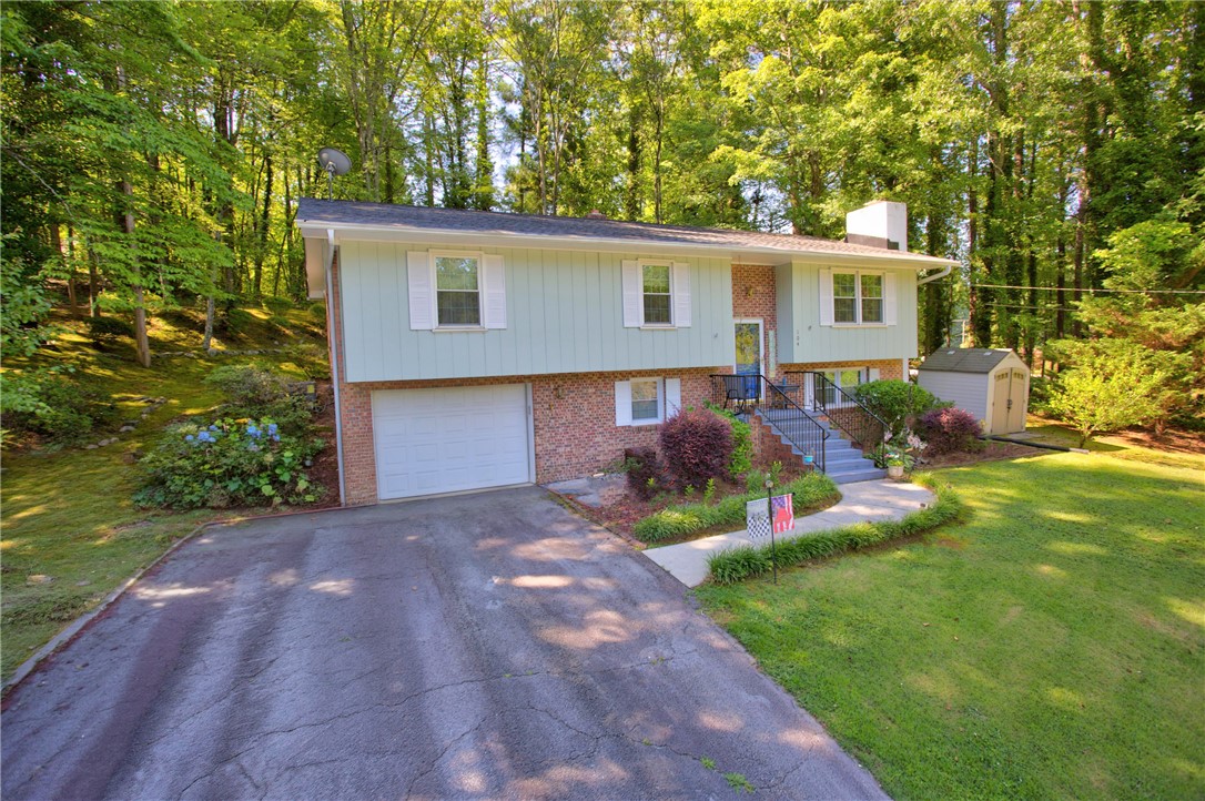 104 Laurel Lane Seneca, SC 29678 - Photo 2 of 36 A classic split-level residence is nestled amongst lush woodlands, offering a private, verdant setting.