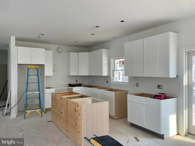 a view of a kitchen with sink cabinets and wooden floor