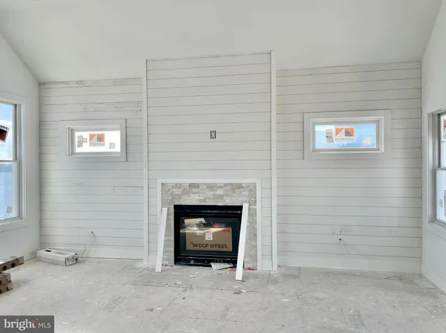 a view of an empty room with a fireplace