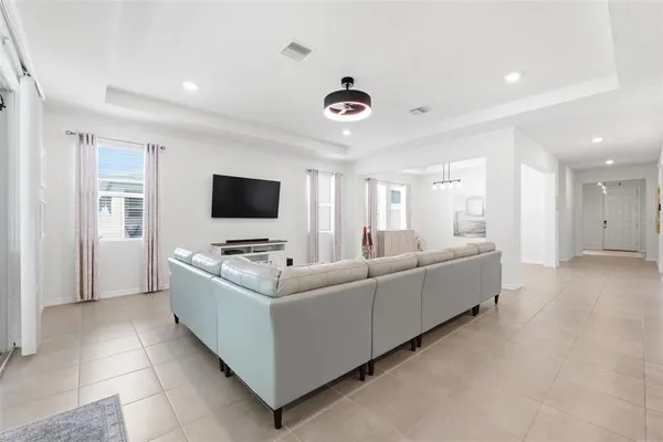 a living room with furniture and kitchen view
