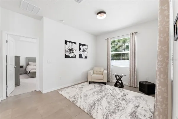 a bedroom with a bed and flat screen tv