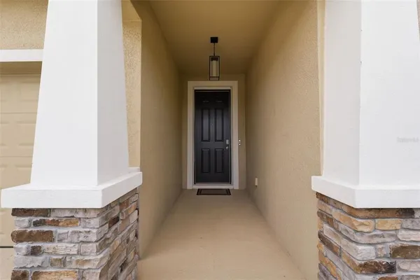 a view of a hallway with wooden floor and a workspace