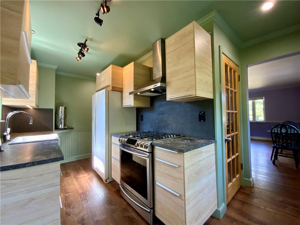 200 Chaplin Drive Coraopolis, PA 15108 - Photo 7 of 25 a kitchen with a stove and a wooden floor