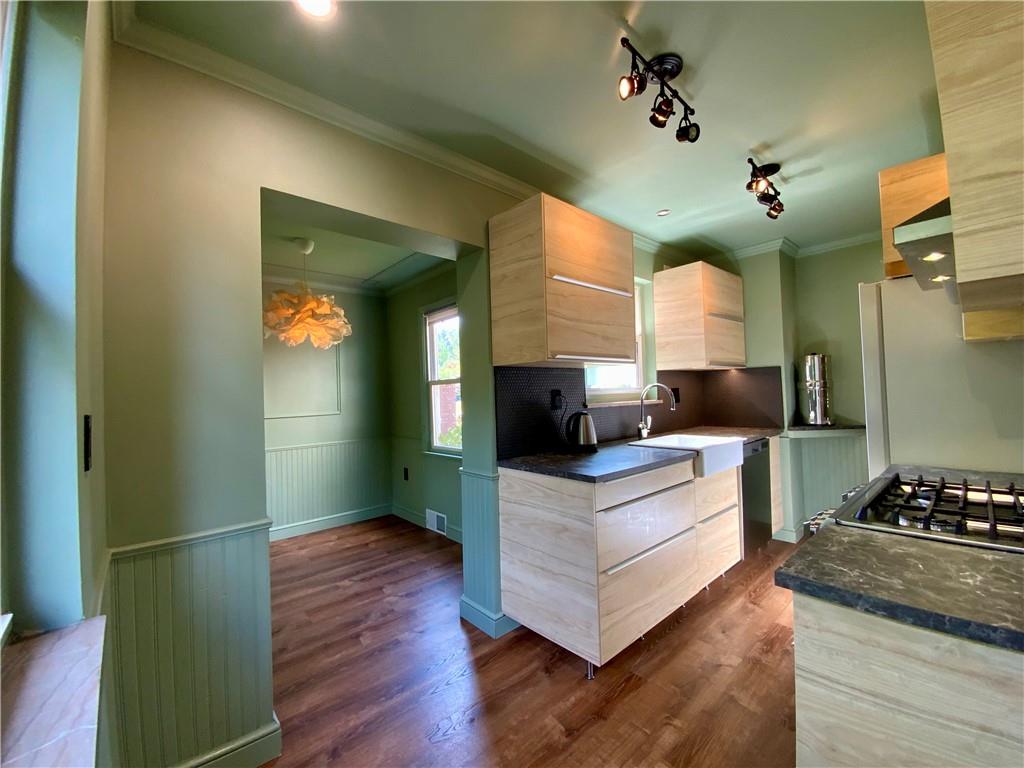 200 Chaplin Drive Coraopolis, PA 15108 - Photo 8 of 25 a kitchen with kitchen island white cabinets and stainless steel appliances