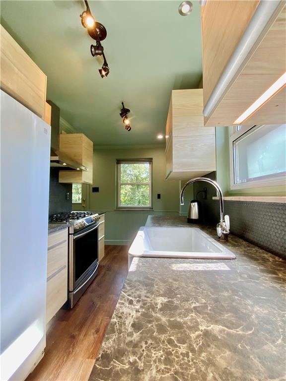 200 Chaplin Drive Coraopolis, PA 15108 - Photo 10 of 25 a kitchen with kitchen island granite countertop a stove and a refrigerator