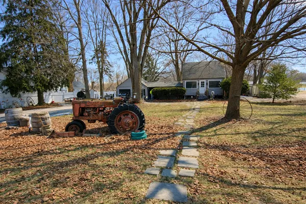 a view of a yard with a house and a tree