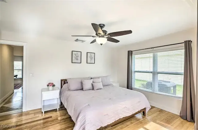 a bedroom with a large bed and a large window