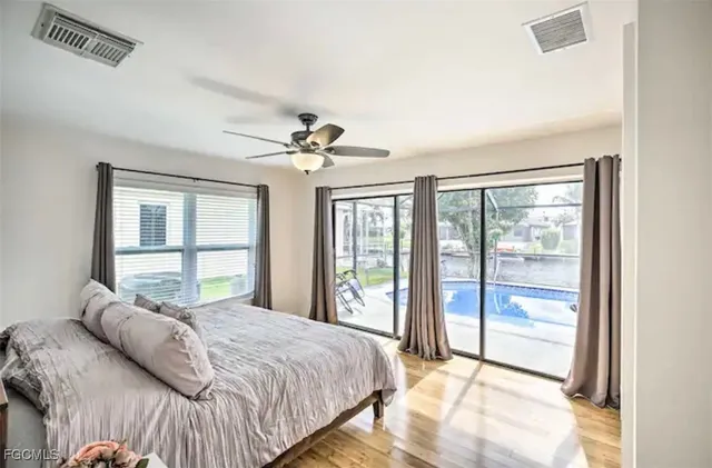 a bedroom with a large bed and a large window