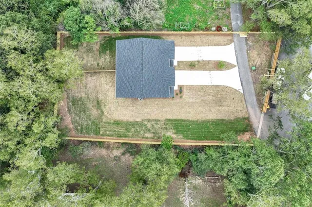 a view of a hallway with wooden floor and a bathroom