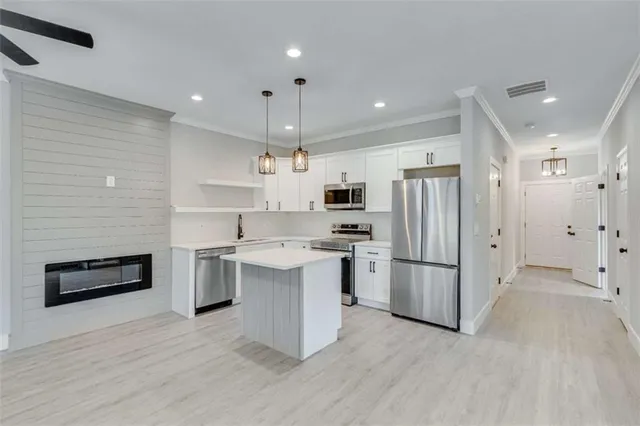 a view of a hallway with a window and a bathroom