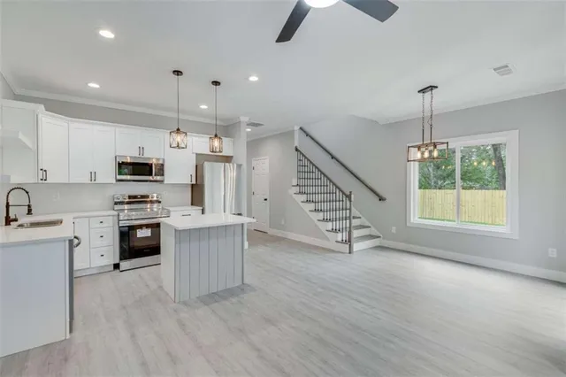 wooden floor in an empty room with a ceiling fan