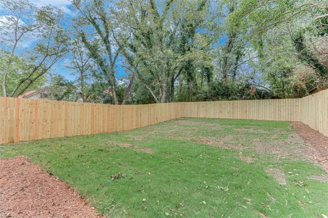 a kitchen with stainless steel appliances kitchen island granite countertop a refrigerator and a stove top oven