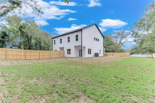 a view of a small house with a backyard