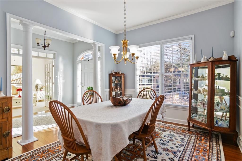 352 Woodbrook Crest Canton, GA 30114 - Photo 14 of 53 a dining room with furniture a chandelier and wooden floor