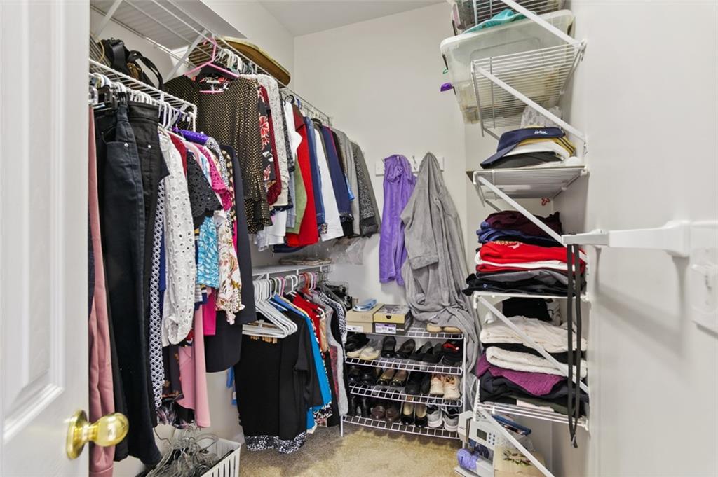 352 Woodbrook Crest Canton, GA 30114 - Photo 22 of 53 a view of walk in closet with clothes