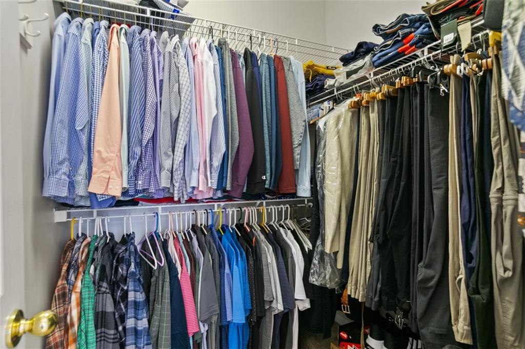 352 Woodbrook Crest Canton, GA 30114 - Photo 23 of 53 a view of walk in closet with clothes