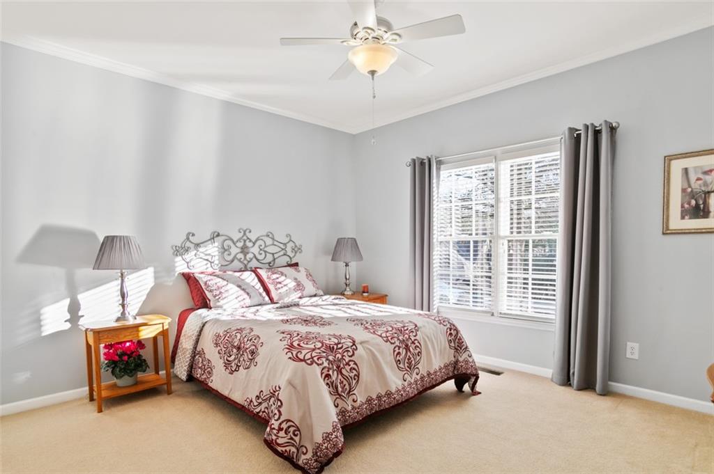 352 Woodbrook Crest Canton, GA 30114 - Photo 24 of 53 a bedroom with a bed and a chandelier