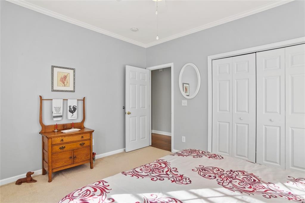 352 Woodbrook Crest Canton, GA 30114 - Photo 25 of 53 a bedroom with a bed and a cabinets