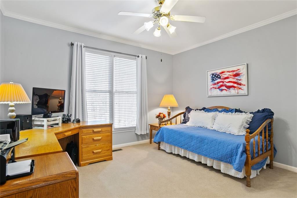 352 Woodbrook Crest Canton, GA 30114 - Photo 28 of 53 a bedroom with a bed and a chandelier