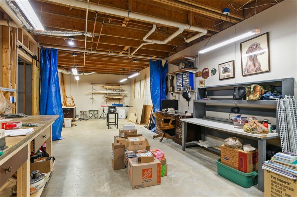 352 Woodbrook Crest Canton, GA 30114 - Photo 34 of 53 a room with lots of furniture and clutter