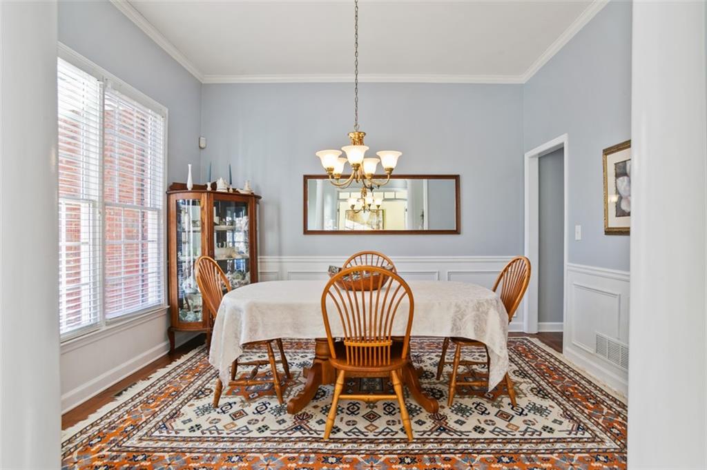 352 Woodbrook Crest Canton, GA 30114 - Photo 4 of 53 a dining room with furniture a rug and wooden floor