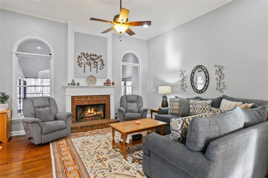 352 Woodbrook Crest Canton, GA 30114 - Photo 5 of 53 a living room with furniture a rug and a fireplace