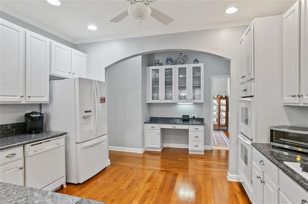 352 Woodbrook Crest Canton, GA 30114 - Photo 6 of 53 a kitchen with granite countertop a stove a sink and a refrigerator