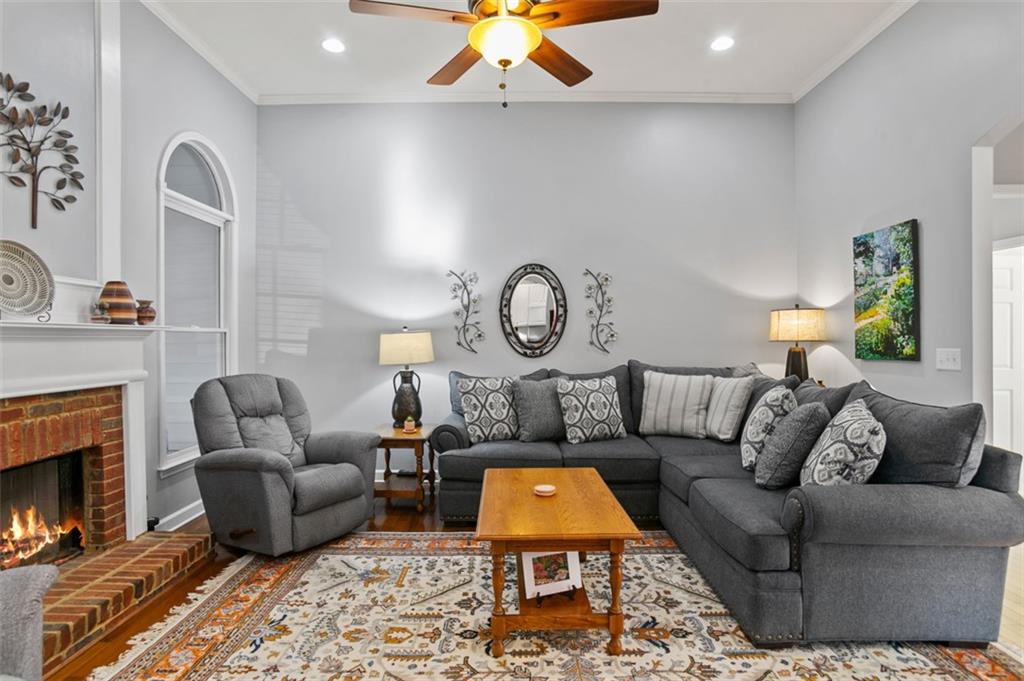352 Woodbrook Crest Canton, GA 30114 - Photo 7 of 53 a living room with furniture a fireplace and a chandelier