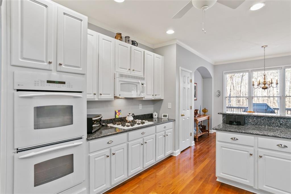 352 Woodbrook Crest Canton, GA 30114 - Photo 9 of 53 a kitchen with stainless steel appliances granite countertop white cabinets granite counter tops and a window