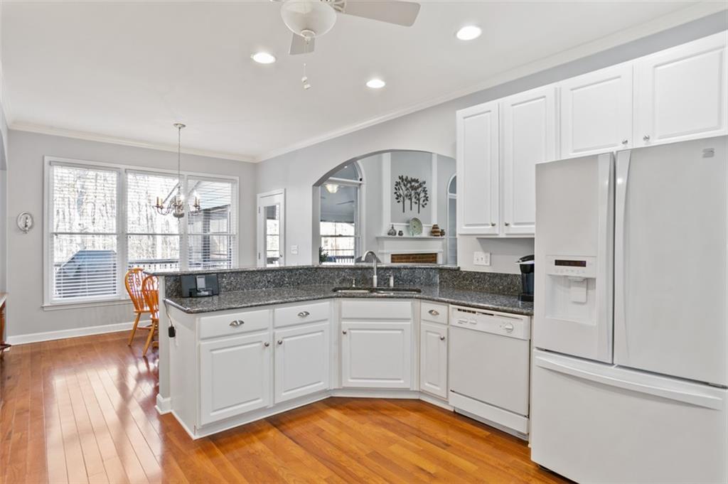 352 Woodbrook Crest Canton, GA 30114 - Photo 10 of 53 a kitchen with granite countertop white cabinets and white appliances