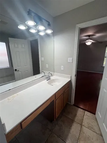 a bathroom with a tub shower and vanity