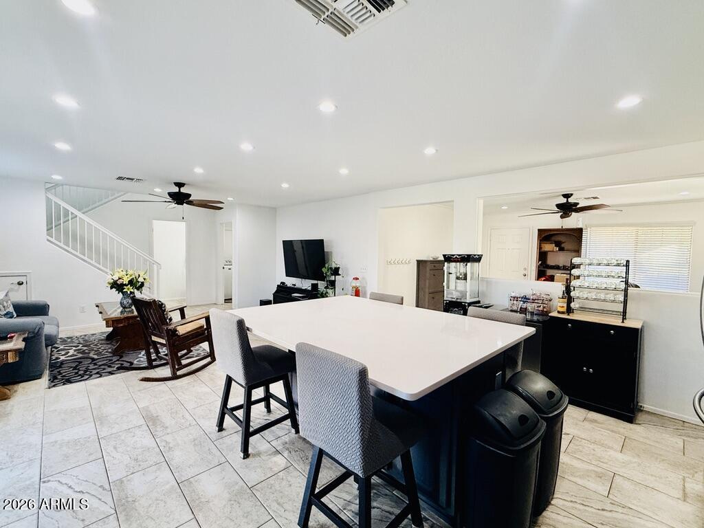 16246 West Boca Raton Road Surprise, AZ 85379 - Photo 11 of 27 a large kitchen with a table and chairs