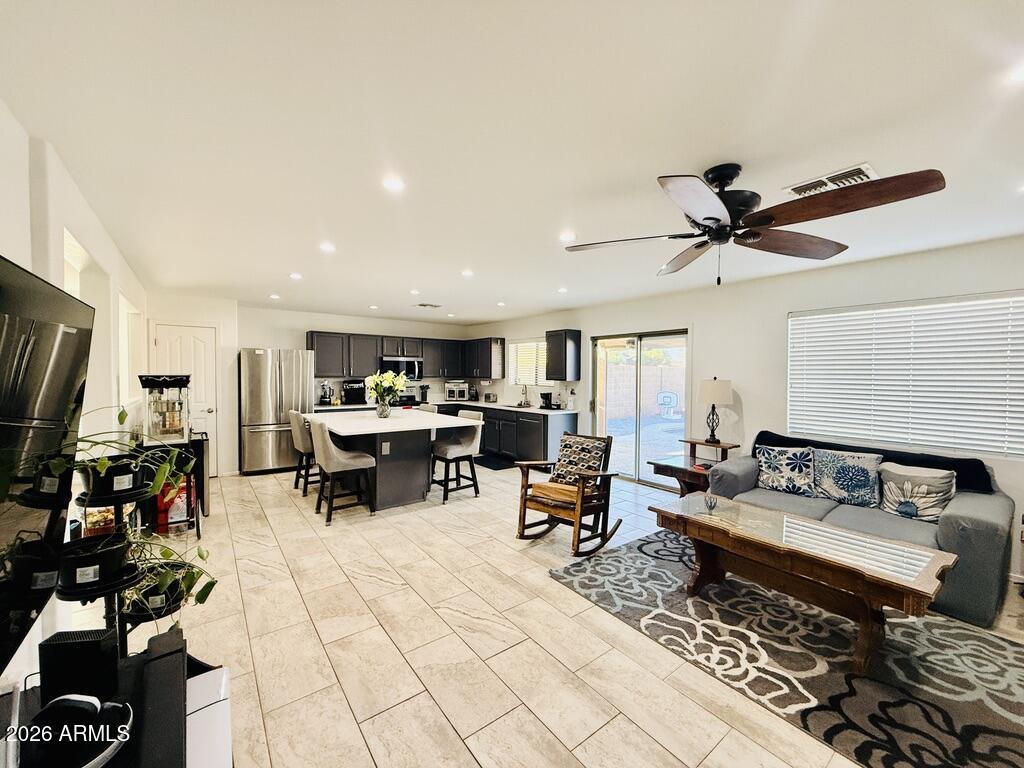 16246 West Boca Raton Road Surprise, AZ 85379 - Photo 13 of 27 a living room with lots of furniture and a ceiling fan