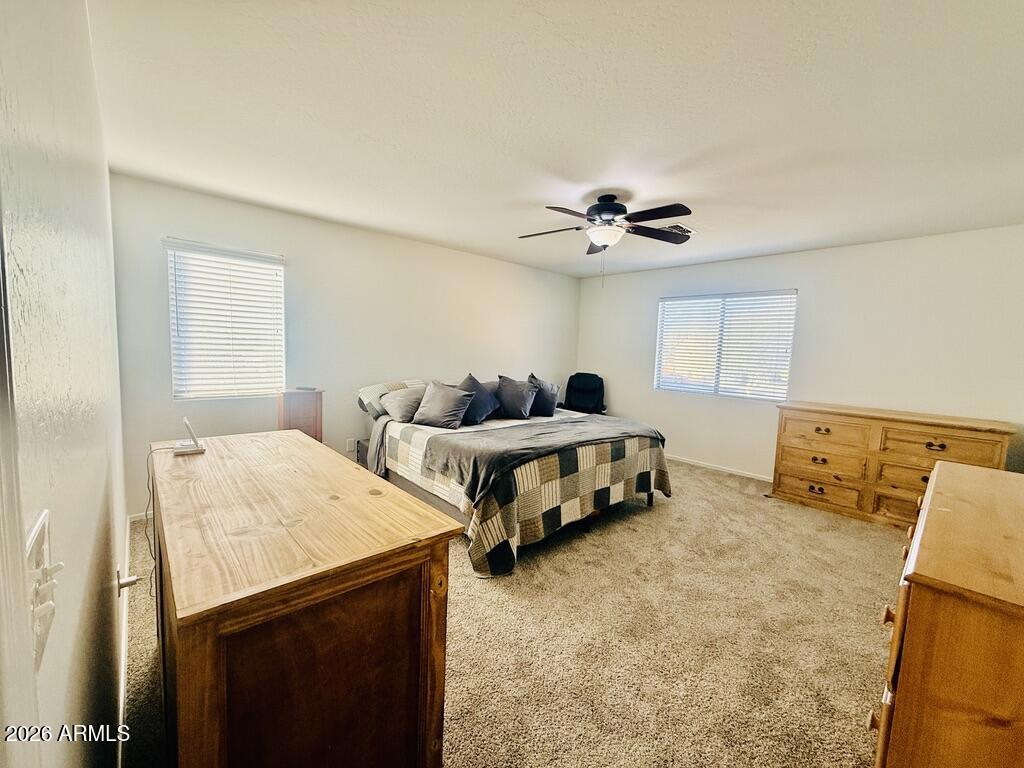 16246 West Boca Raton Road Surprise, AZ 85379 - Photo 16 of 27 a bed room with two bed and a ceiling fan