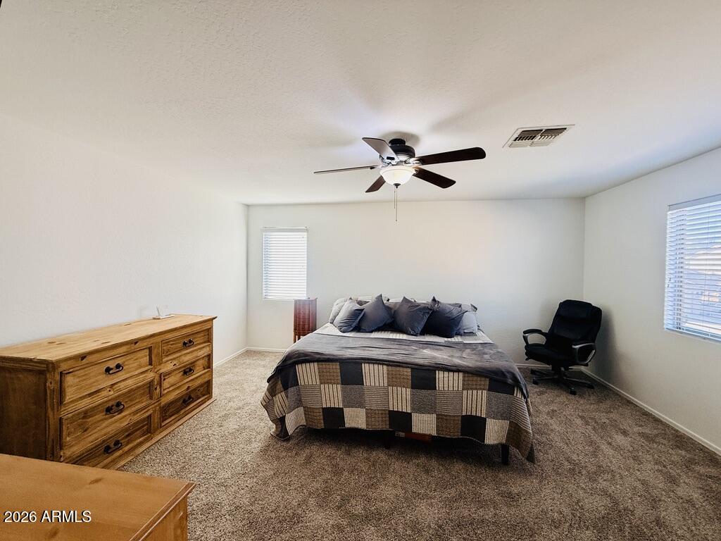 16246 West Boca Raton Road Surprise, AZ 85379 - Photo 17 of 27 a bedroom with a bed and a chandelier