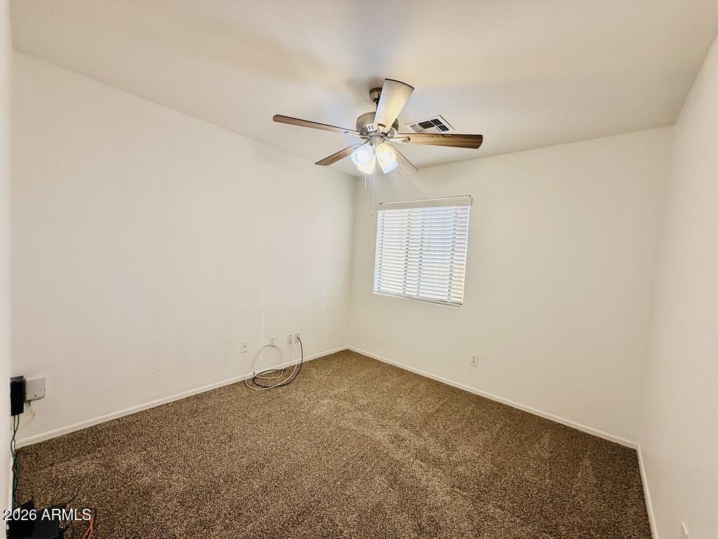 16246 West Boca Raton Road Surprise, AZ 85379 - Photo 20 of 27 an empty room with a window and a fan