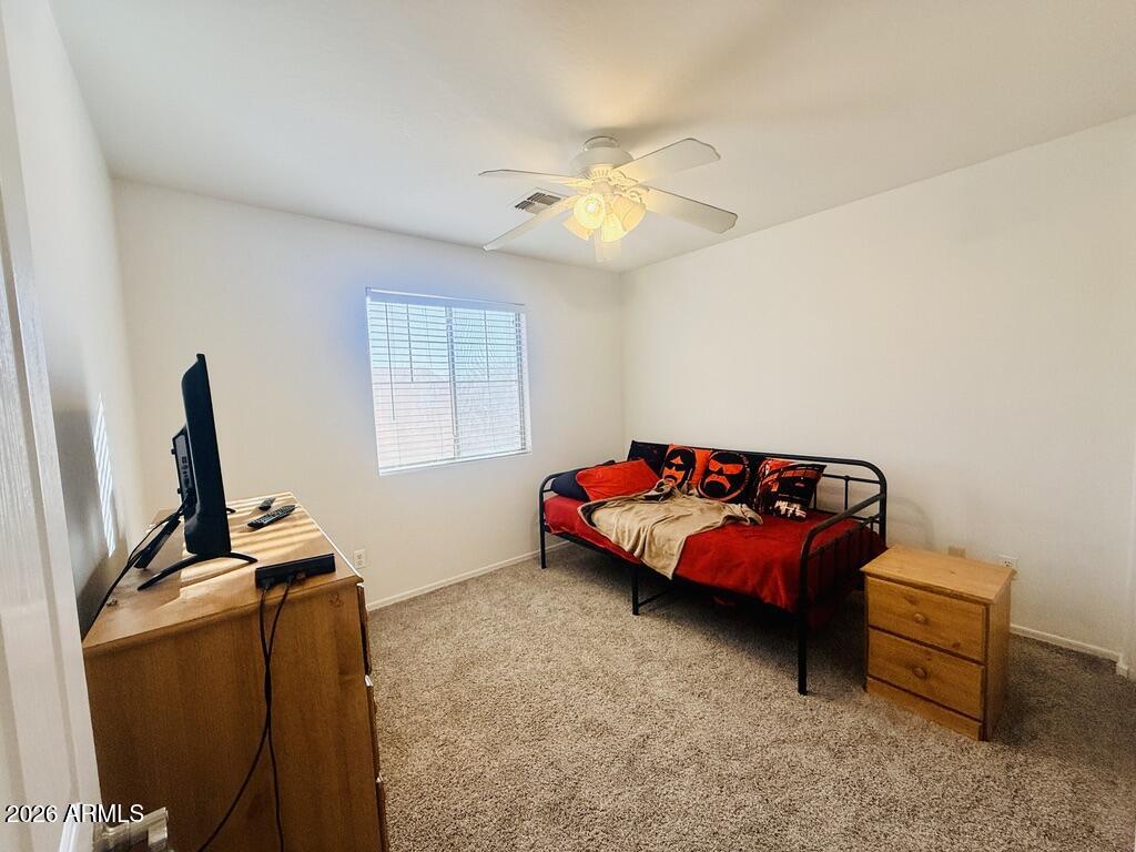 16246 West Boca Raton Road Surprise, AZ 85379 - Photo 22 of 27 a bedroom with furniture and a window