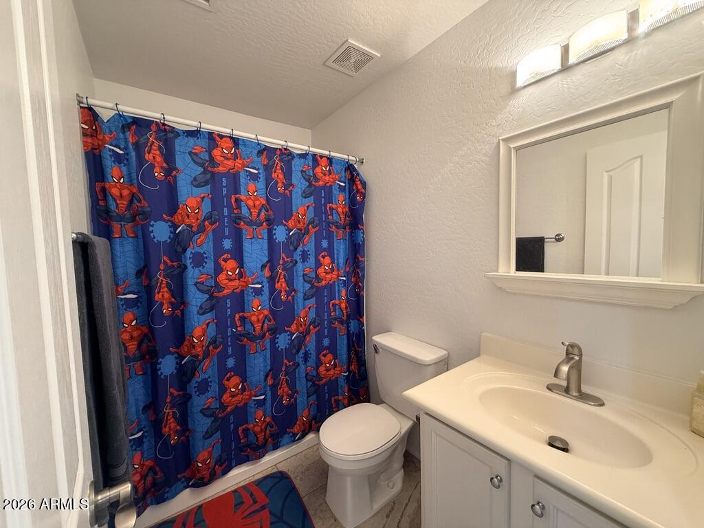 16246 West Boca Raton Road Surprise, AZ 85379 - Photo 23 of 27 a bathroom with a sink toilet and shower