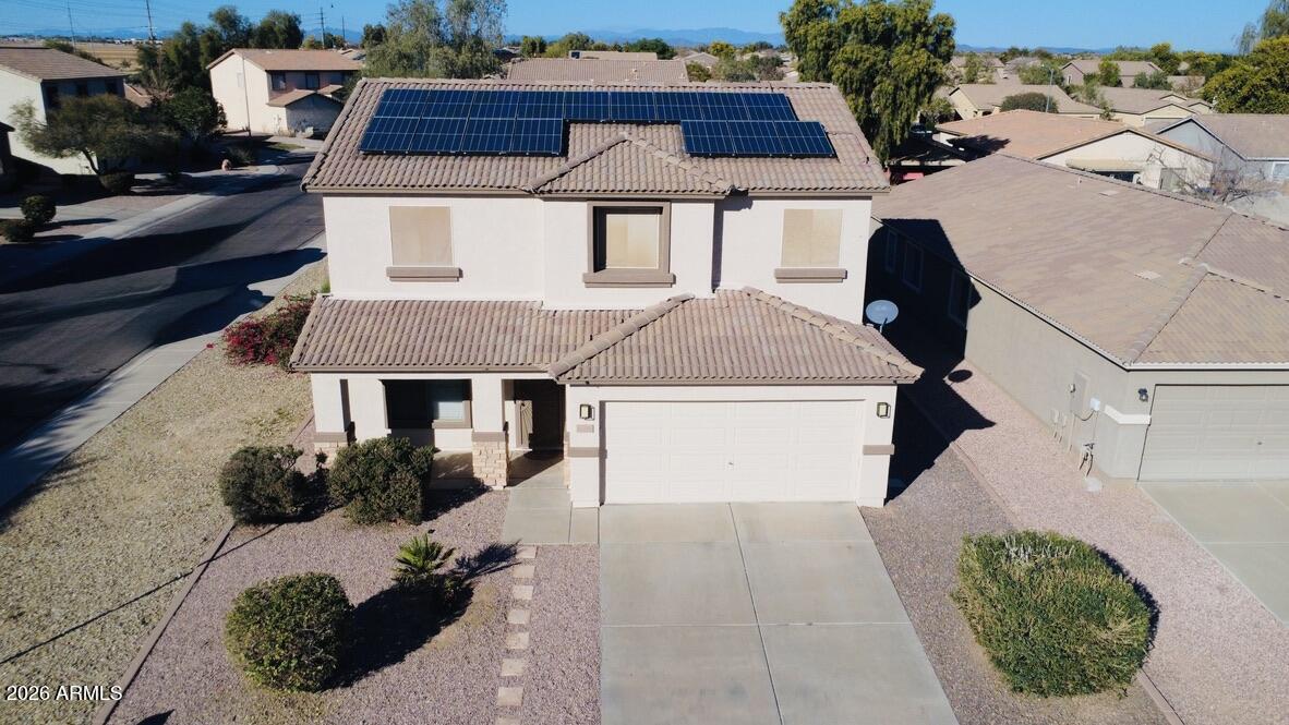 16246 West Boca Raton Road Surprise, AZ 85379 - Photo 3 of 27 a view of a house with a yard and potted plants