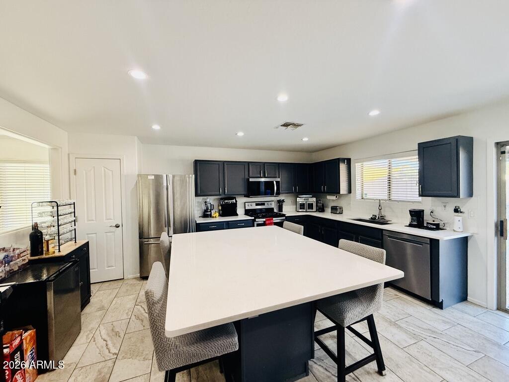 16246 West Boca Raton Road Surprise, AZ 85379 - Photo 7 of 27 a large kitchen with a table and chairs