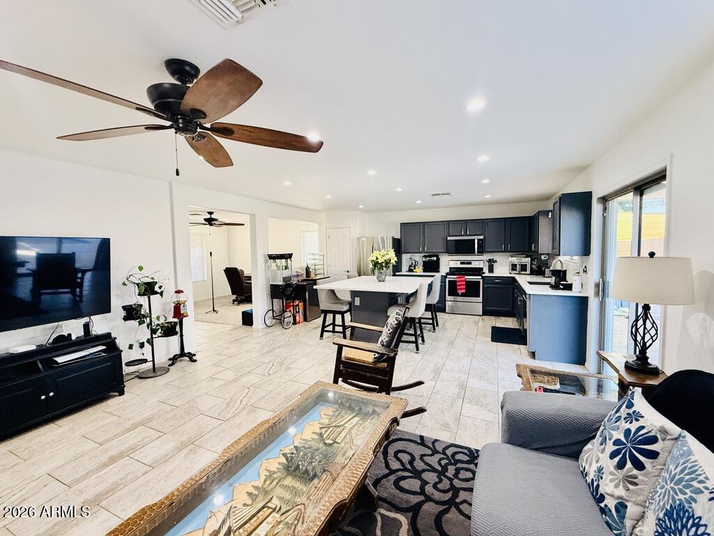 16246 West Boca Raton Road Surprise, AZ 85379 - Photo 9 of 27 a living room with furniture and a flat screen tv
